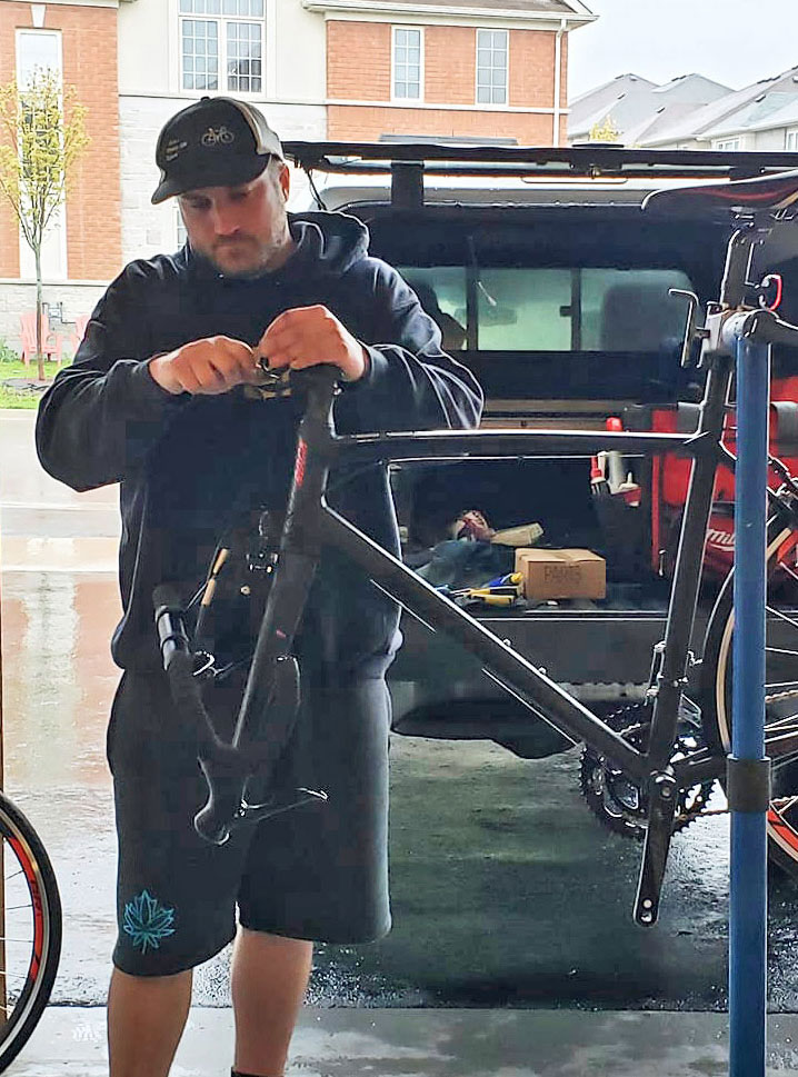 Mike fixing bike in garage sized for mobile